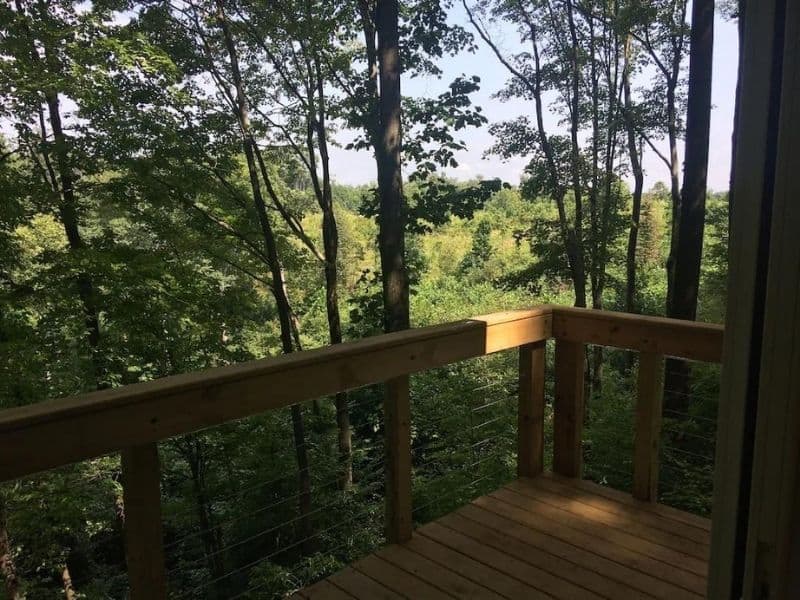 Deck and view at a romantic treehouse cabin in hocking hills that's pet friendly