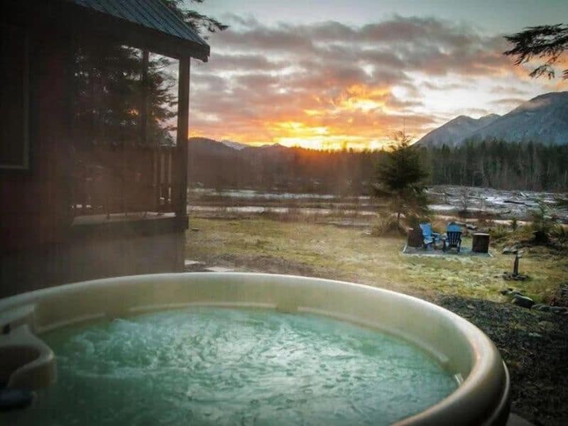 Hot tub overlooking river at cabin rental near Mt Rainier