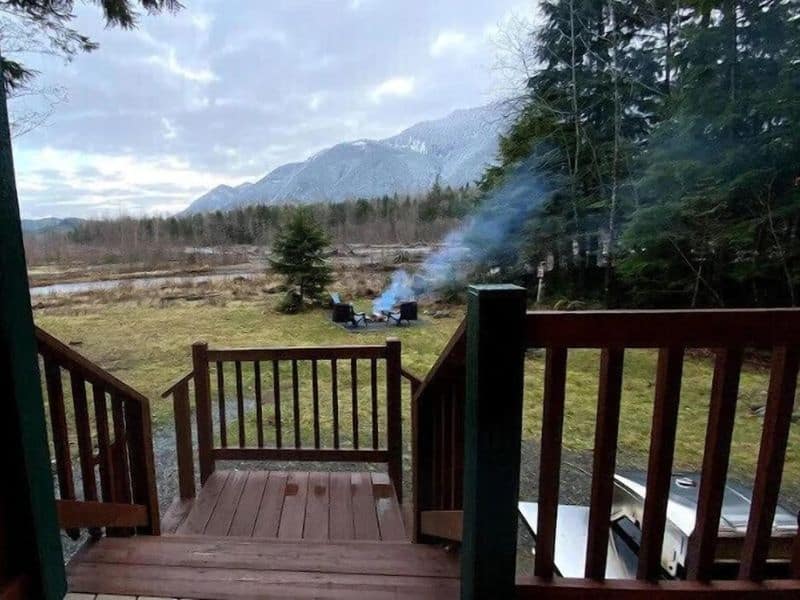 Wood deck at Mt Rainier cabin rental with outdoor chairs and fire pit