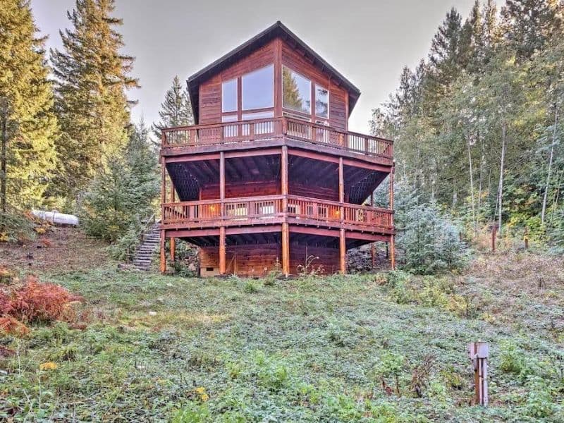 A three-story log cabin rental near Mount Rainier with two large decks and huge windows.