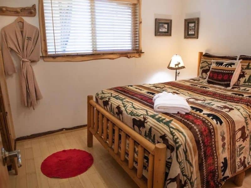 Rustic bedroom in Mt Rainier cabin rental with forest themed bedding