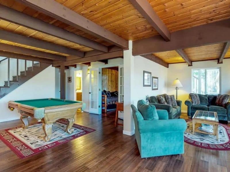 Living room at pool table at Pine Mountain Magic cabin near Yosemite