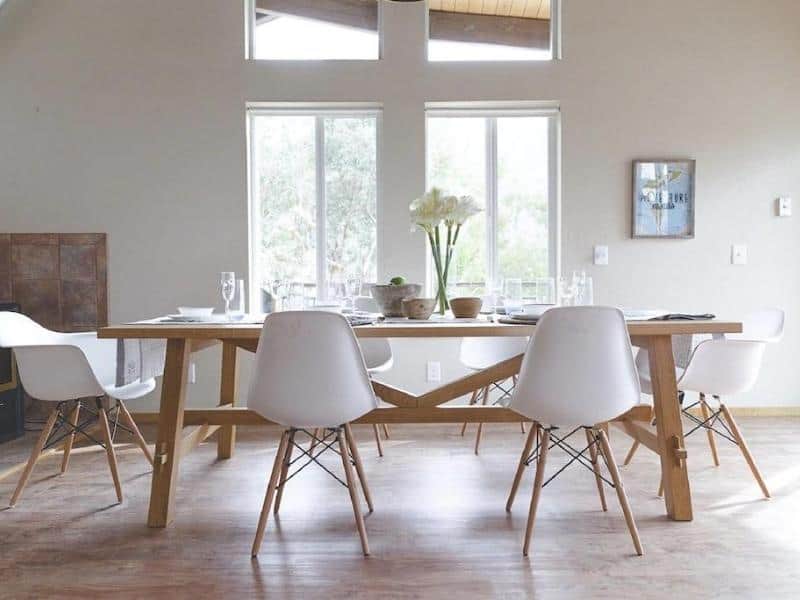 Bright dining room with large windows and a wooden table set in a Vrbo home rental located inside Sequoia National Park.
