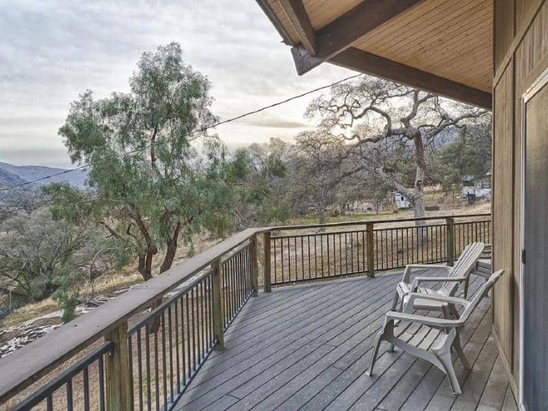 Deck with outdoor seating overlooking the landscape near Sequoia National Park at a Vrbo inside the park gates.