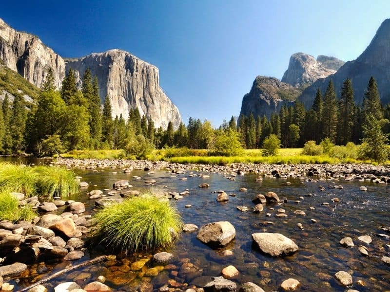 View of Yosemite Valley with river in the foreground.