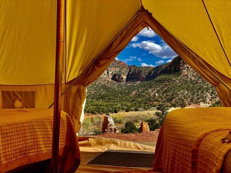 View of Zion red rocks from a canvas glamping tent at Zion Glamping Adventures
