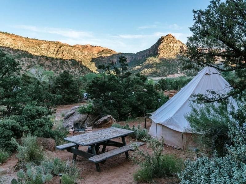 Glamping site at Zion Glamping Adventures including canvas bell tent and picnic table