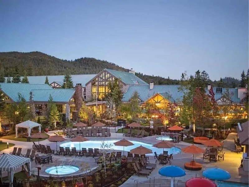 The exterior of chalet style Tenaya Lodge in Fish Camp, California at dusk - located on the border of Yosemite National Park