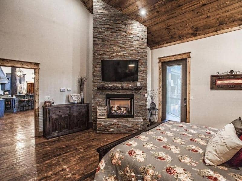 Bedroom with fireplace in Lusa Nita Luxury Retreat in Broken Bow, Oklahoma