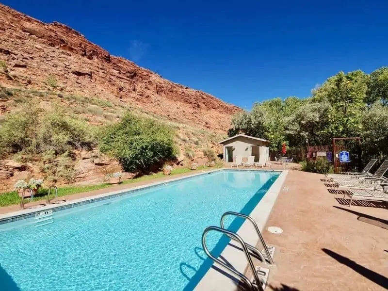 Outdoor pool set against Utah red rocks near Arches National Park in Moab.
