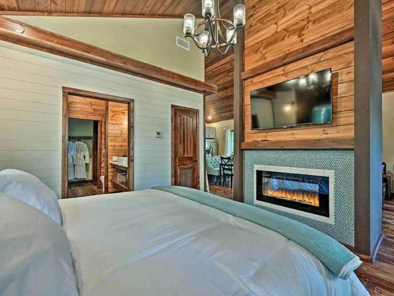 Bedroom with fireplace in Modern Couples Retreat - Luxury Cabin in Broken Bow
