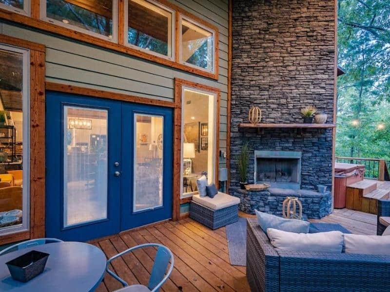 Outdoor entertainment area with fireplace at Broken Bow Luxury Cabin
