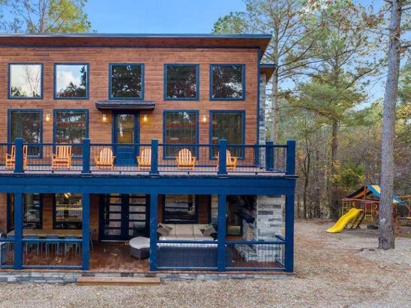 Exterior of luxury cabin with playground in Broken Bow, OK