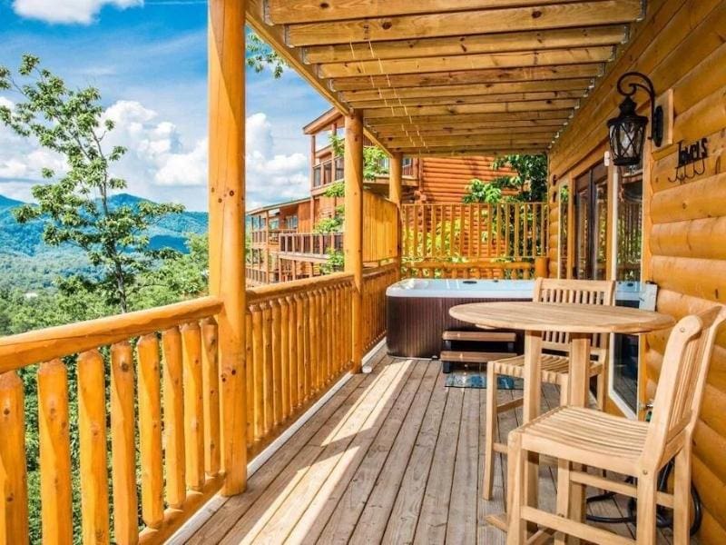 Pigeon Forge cabin with large wooden deck with hot tub and seating
