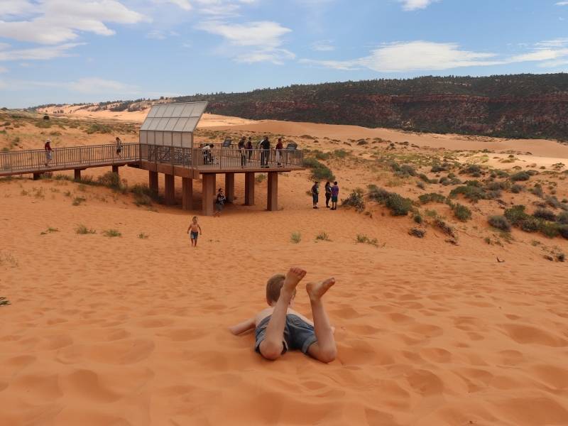 Kids playing in the sand at Coral Pink Sand Dunes State Park in Utah