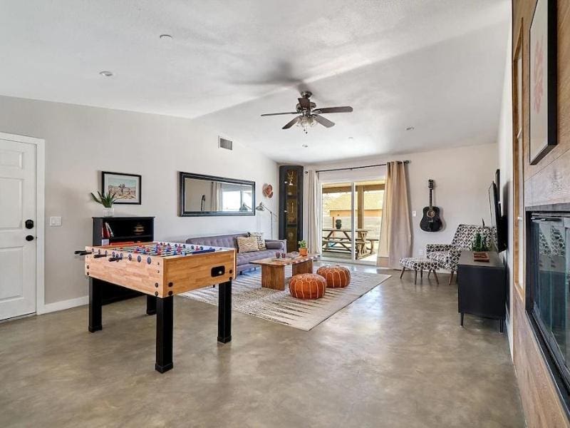 Living room and game area at home rental in Joshua Tree