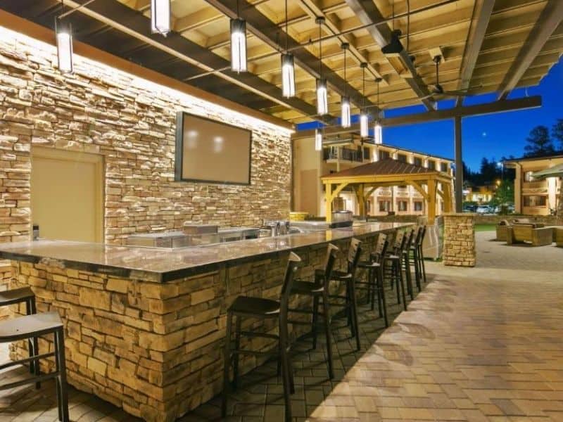 Outdoor covered bar seating with TV at Best Western Premier Grand Canyon Squire Inn