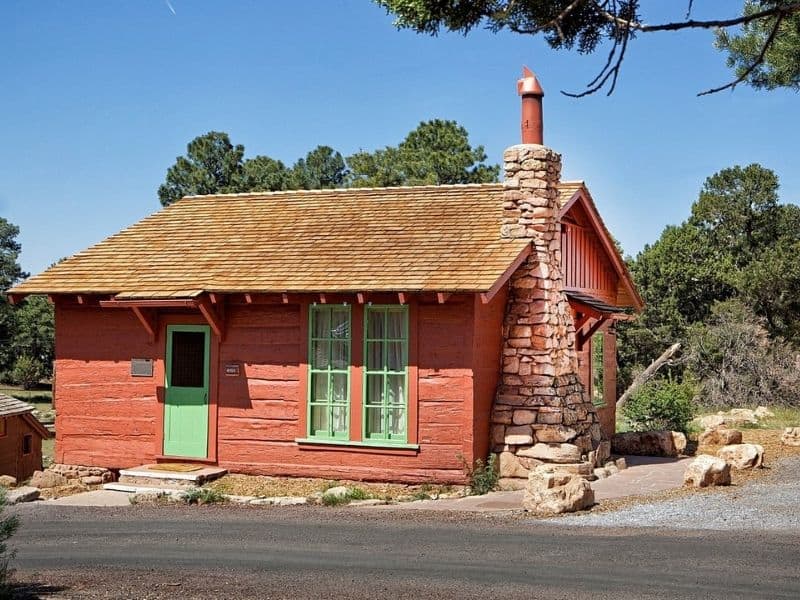 Exterior of red cabin with green door and windows at Bright Angel Lodge and Cabins on the Grand Canyon South Rim