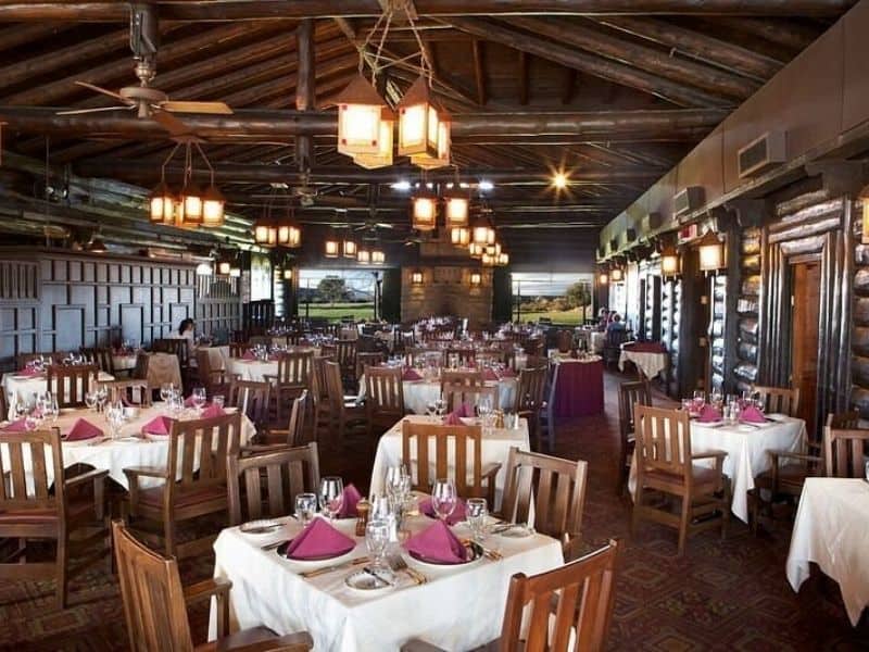 Historic dining room with wood accents and hanging lantern chandeliers at El Tovar on the Grand Canyon South Rim