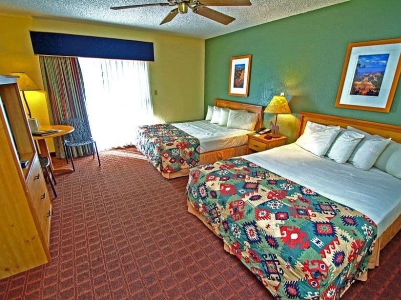 Queen guest room at Maswik Lodge near the Grand Canyon South Rim with two beds, red carpet floor, and a ceiling fan