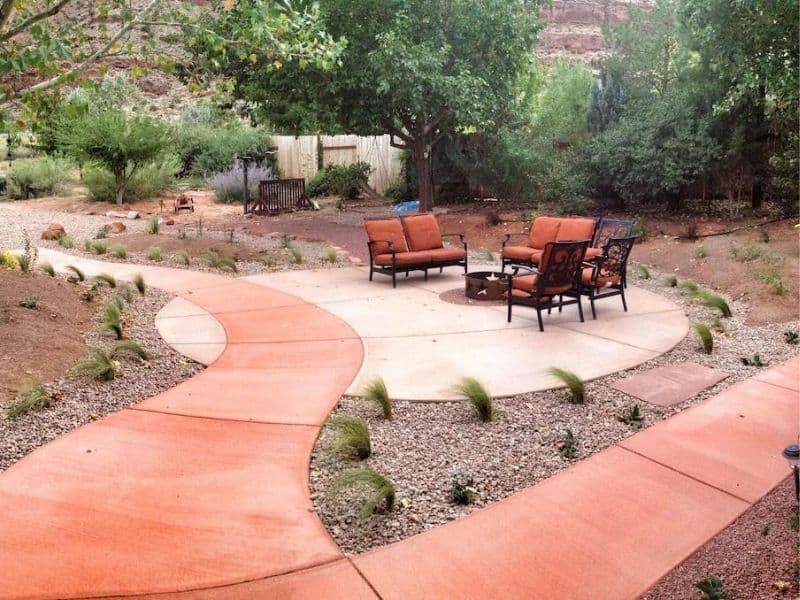 Inviting outdoor seating area at an Airbnb in Moab with a winding concrete path and desert-adapted landscaping