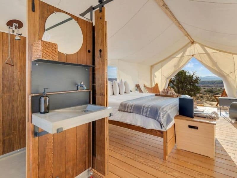 Interior of canvas tent suite at Under Canvas Grand Canyon with king bed and ensuite bathroom