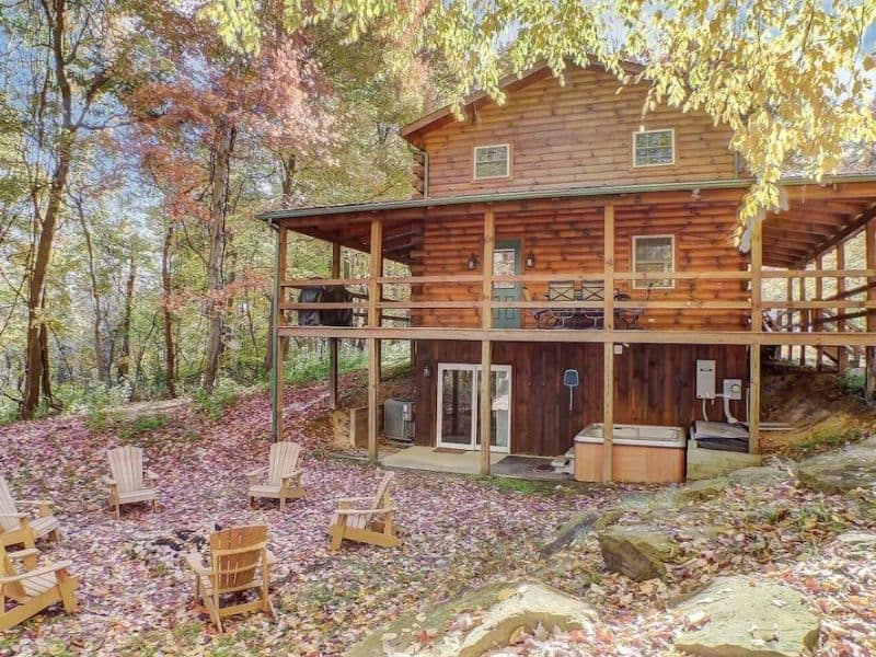 Traditional cabin rental in Hocking Hills with hot tub, wraparound deck and Adirondack chairs