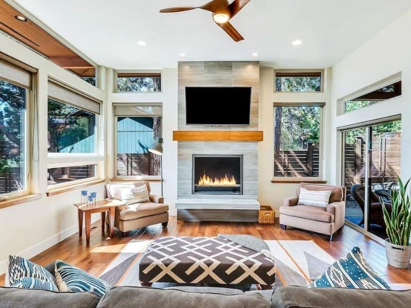 Living room with fireplace in a 2-bedroom mid-century home rental in Bend, OR.