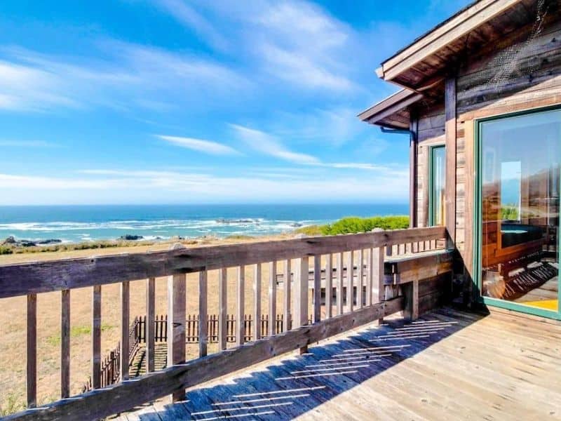 Outdoor wood porch with ocean views at a rental home in Fort Bragg, CA.