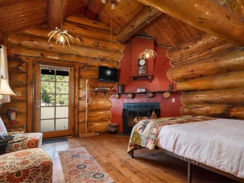 Log cabin room with fireplace at Bar N Ranch in West Yellowstone - Lodging near Yellowstone National Park
