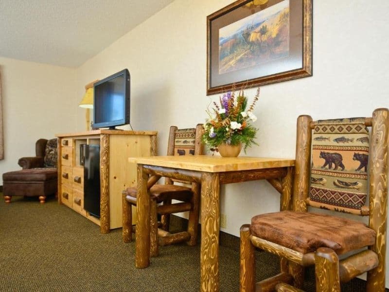 Guest room at Kelly Inn in West Yellowstone with TV and small wood table and chairs