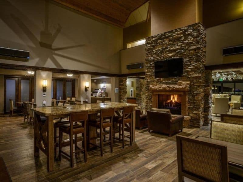 Reception at Zion Holiday in Express with seating and stone fireplace. Lodging near Zion National Park