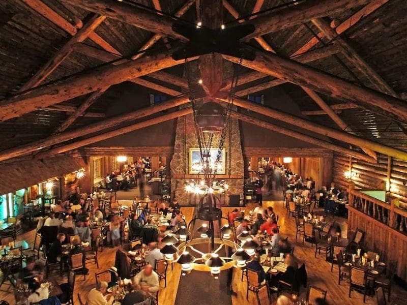 Traditional dining room at Old Faithful Inn with high vaulted ceilings and exposed log beams