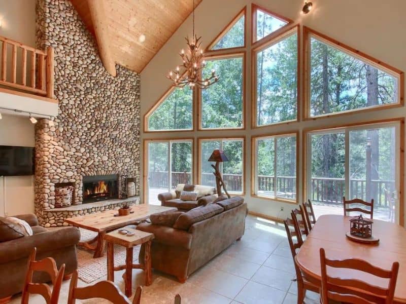 Living area with large stone fireplace near Yosemite