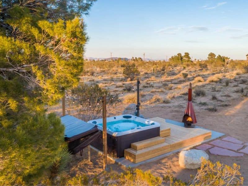 Outdoor hot tub and fireplace at one of the prettiest airbnbs in Joshua Tree - Flamingo Social Club