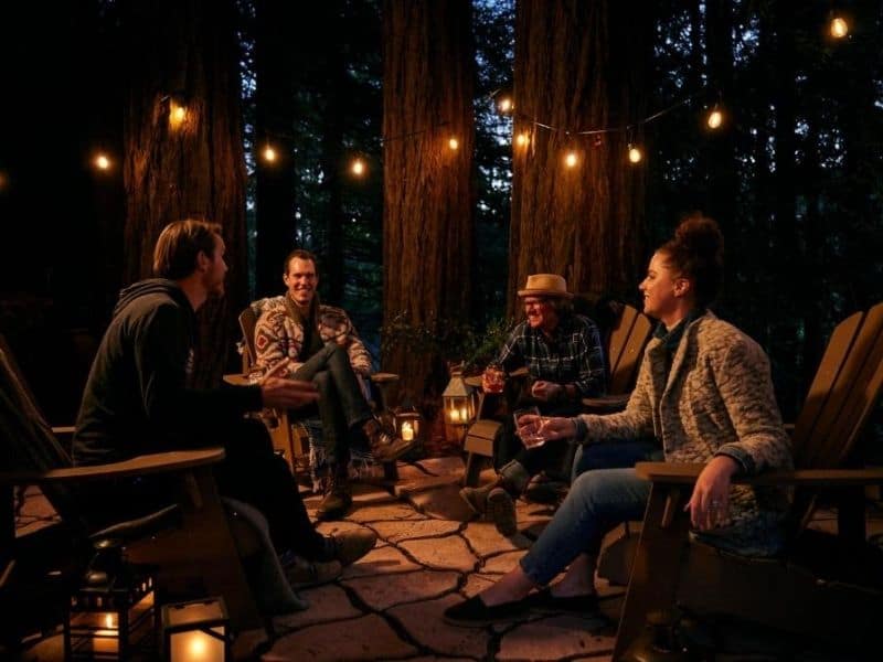People sitting in a circle and talking at Highlands Resort - Bay Area Glamping
