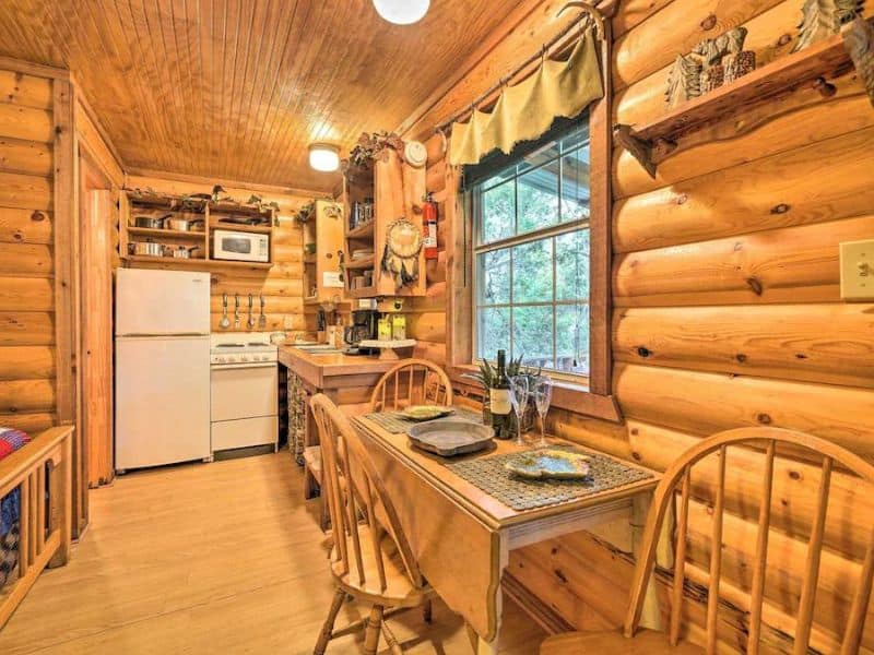 Interior of Cozy Davis Cabin in Turner Falls with kitchen and dining table