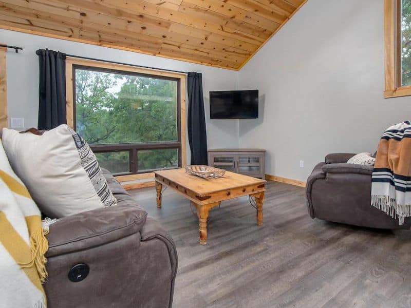 Living room with tv at vacation rental near Turner Falls