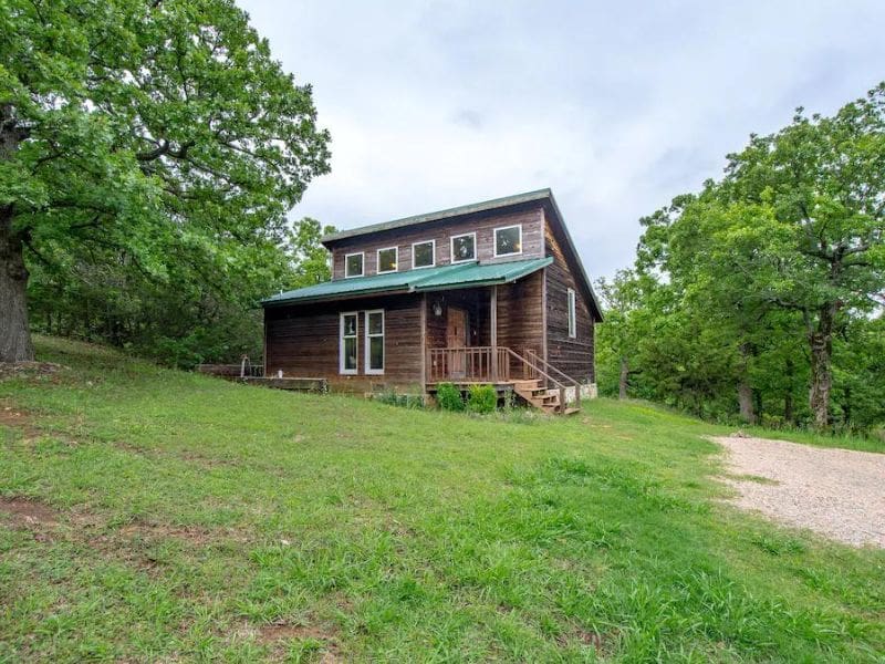 Rustic wood cabin exterior of Vrbo near Turner Falls