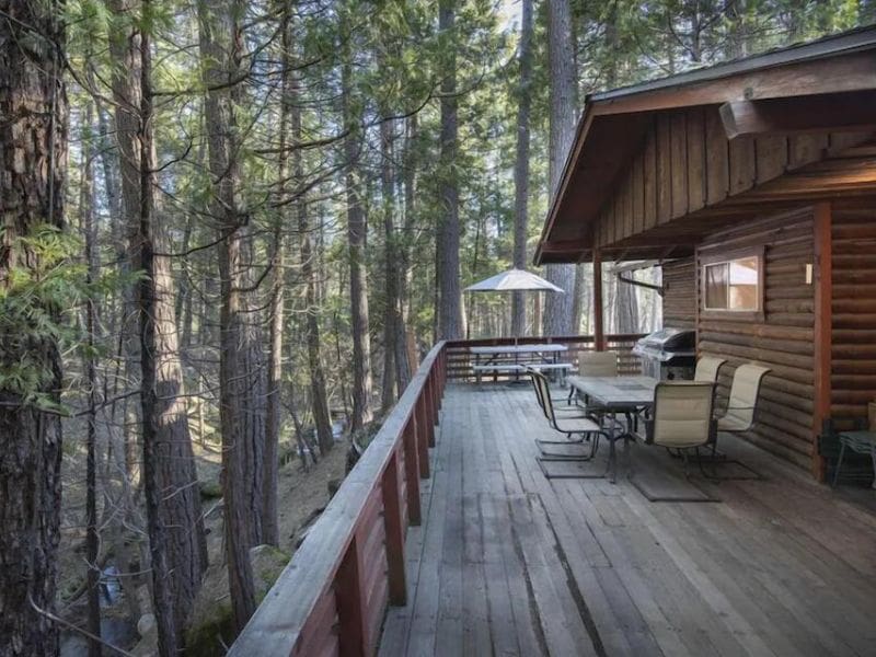 Traditional wood cabin with large deck in a pine forest near Yosemite, CA