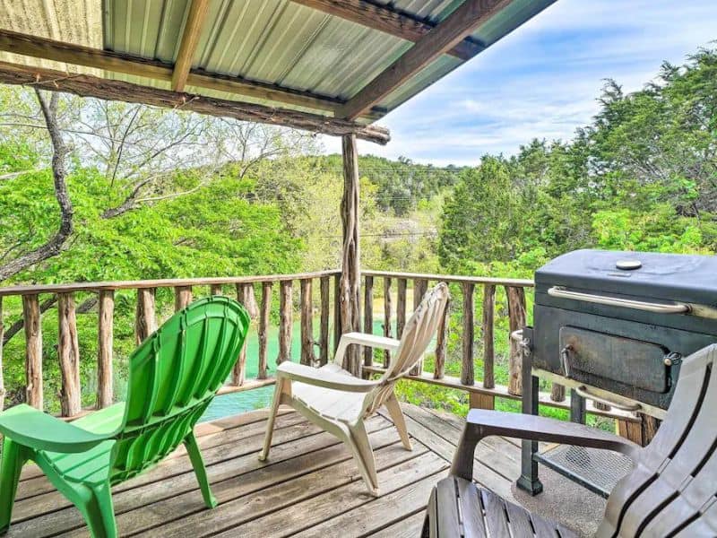 Deck overlooking a river at Rustic Davis Cabin - Cabins in Turner Falls