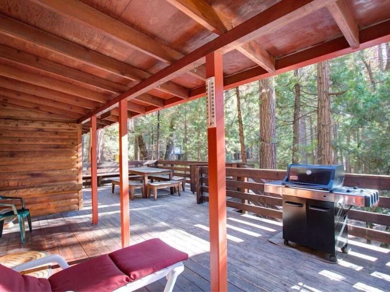 Outdoor deck surrounded by forest at Yosemite cabin in Wawona