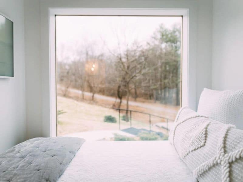 Bed with large window at tiny home rental near Hocking Hills