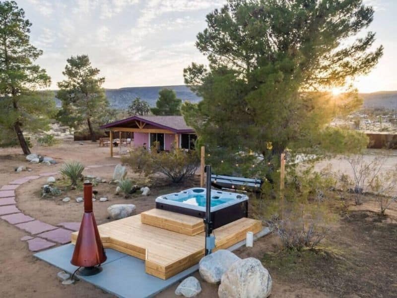 Hot tub and outdoor fireplace at Flamingo Social Club Joshua Tree Airbnb / Vrbo