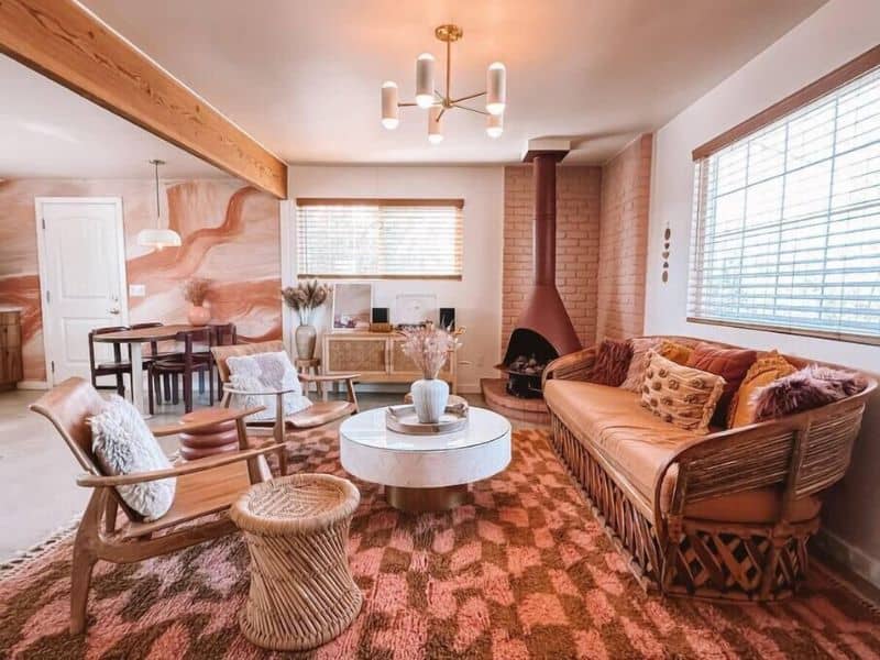 Trendy pink and wine red interior with fireplace at one of the prettiest Airbnbs in Joshua Tree