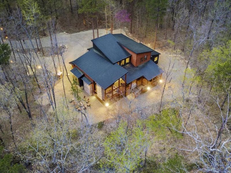 Aerial view of Living Water Lodge, a spacious Broken Bow 5-bedroom cabin surrounded by bare trees.