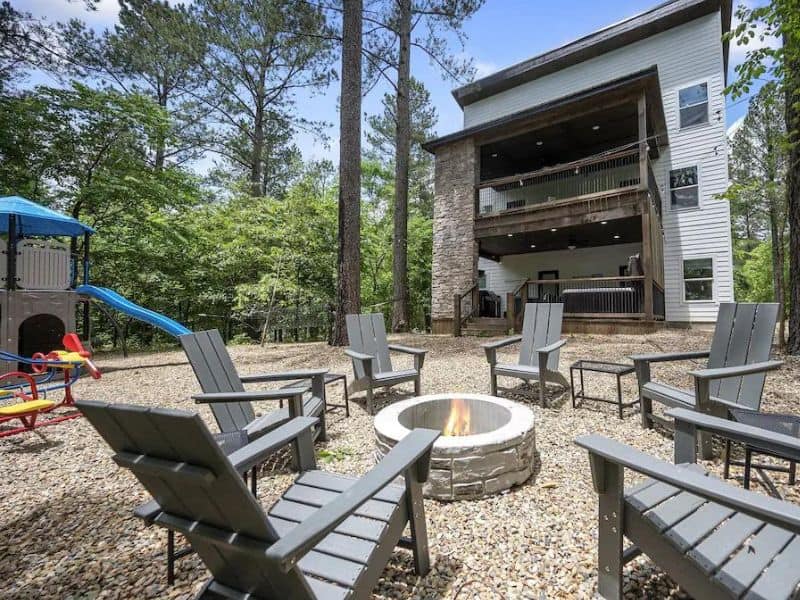 Large cabin in Broken Bow, Oklahoma with a fire pit and outdoor play area for kids