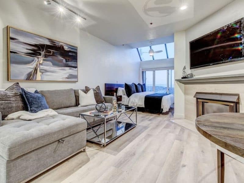 Modern living room with a plush sectional sofa and a sleek glass coffee table in a Park City ski in ski out condo rental.