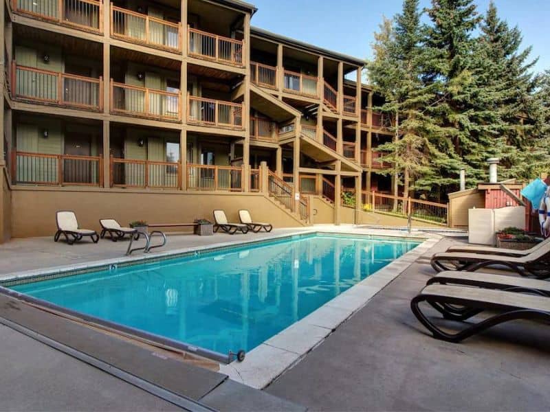 Community swimming pool with lounge chairs at Snowcrest Condos in Park City UT.