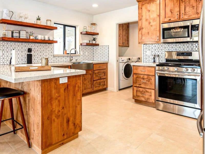 Modern kitchen with wood cupboards and mosaic tiles at Joshua Tree vacation rental